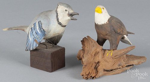 Carved and painted bald eagle, 5 1/2'' h., and a blue jay, ca. 1970, 5 3/4'' h.