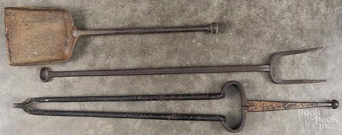 Three iron fire tools, 19th c., to include a fork, tongs, and a shovel, longest - 29''.
