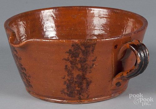 Pennsylvania redware spouted bowl, 19th c., with manganese decoration, 4 1/4'' h., 8 1/2'' dia.