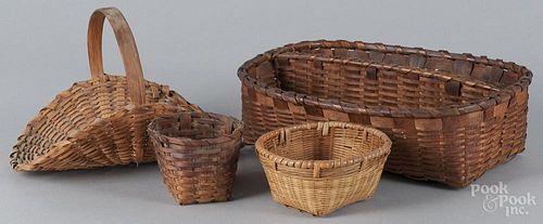Split oak utensil basket, 19th c., 3 1/2'' h., 12 1/4'' w., together with three other baskets.