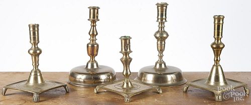 Two bell based brass candlesticks, probably early 20th c., together with three platform base sticks