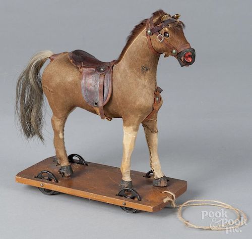 Hide covered horse pull toy, ca. 1900, 10'' h., 9 1/2'' l. Provenance: The Estate of Mark and Joan Eaby