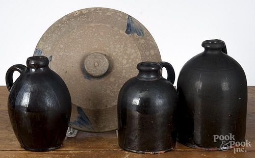Three redware jugs, 19th c., tallest - 8'', together with a stoneware lid, 11 1/2'' dia.
