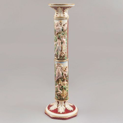 Columna. Italia, sXX. Elaborada en porcelana Capodimonte. Decorada con amorcillos, esmalte dorado, motivos vegetales. 96 cm de altura.