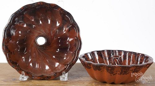 Two Pennsylvania redware Turk's head molds, 19th c., with manganese decoration, 8 1/4'' dia.