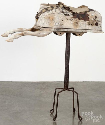 Carved and painted remnant of a rocking horse, 19th c., mounted to an iron base, overall - 43'' h.