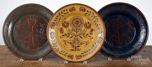 Three Foltz sgrafitto redware chargers, 13'' dia. Provenance: The Estate of Mark and Joan Eaby