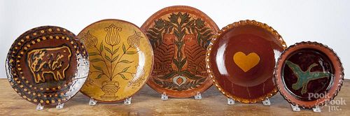 Five Foltz redware dishes, largest - 11 3/4'' dia. Provenance: The Estate of Mark and Joan Eaby