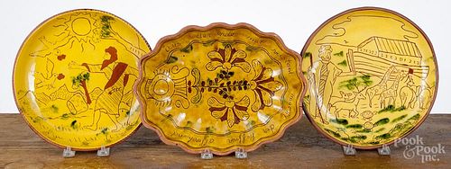 Two Breininger sgrafitto redware plates, 9 1/4'' dia., together with an oblong dish, 11 1/4'' l.