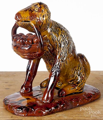 Lester Breininger, redware dog with a basket, signed and dated 1971, 4 3/4'' h.