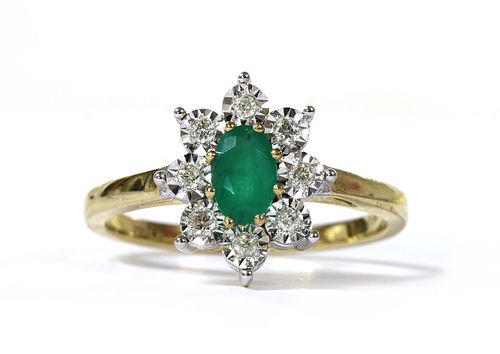 A gold emerald and diamond cluster ring,