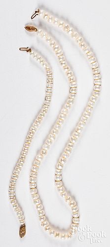 Two pearl necklace with gold clasps.