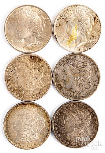 Six silver dollars, to include Morgan and Peace