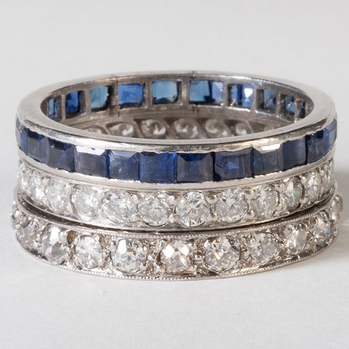 Two Platinum and Diamond Band Rings and a Platinum and Sapphire Band Ring