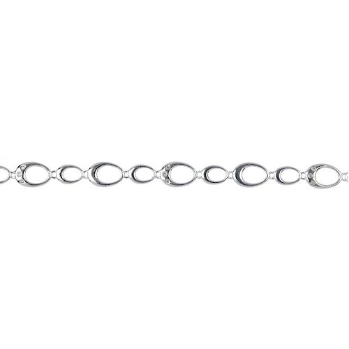 A 9ct gold bracelet. Designed as a series of alternating oval-shape polished and single-cut diamond