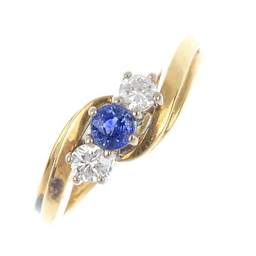 An 18ct gold sapphire and diamond crossover ring. The circular-shape sapphire, with brilliant-cut di