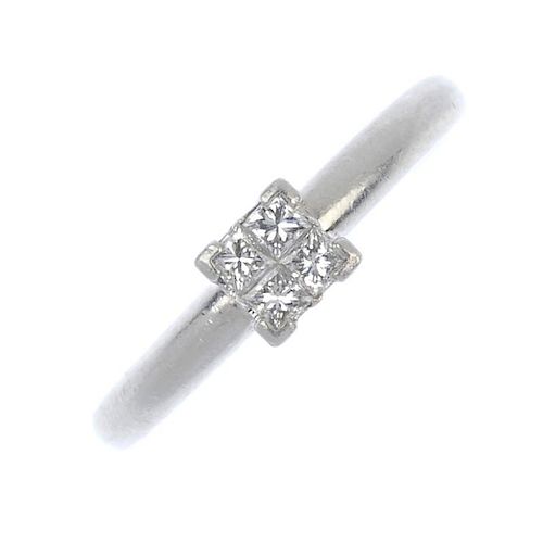 A platinum diamond single-stone ring. The square-shape diamond quatrefoil, to the plain band. Total