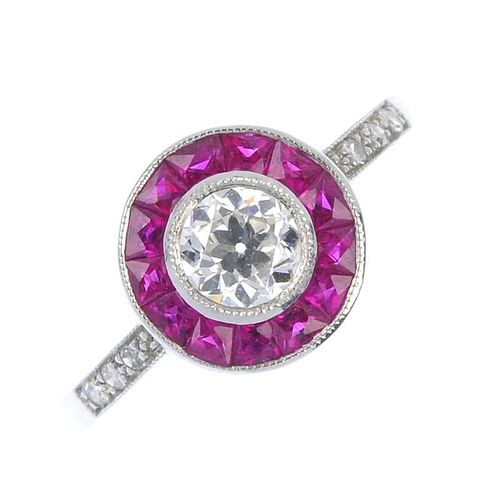 An 18ct gold ruby and diamond cluster ring. The old-cut diamond, within a calibre-cut ruby circular