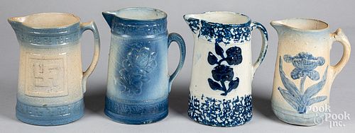 Four blue and white stoneware pitchers, ca. 1900