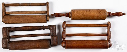 Four antique wood rolling pins.