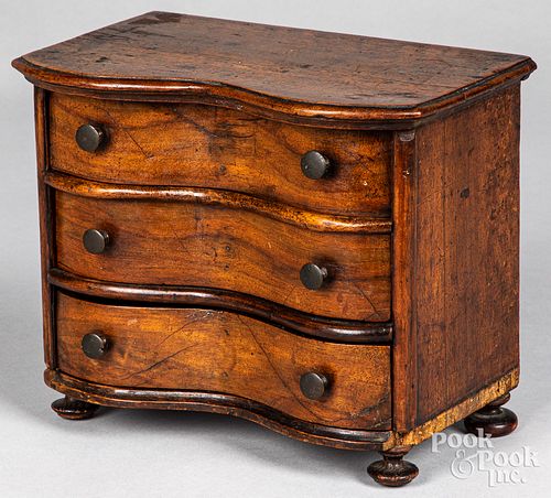 Miniature serpentine front walnut chest of drawers