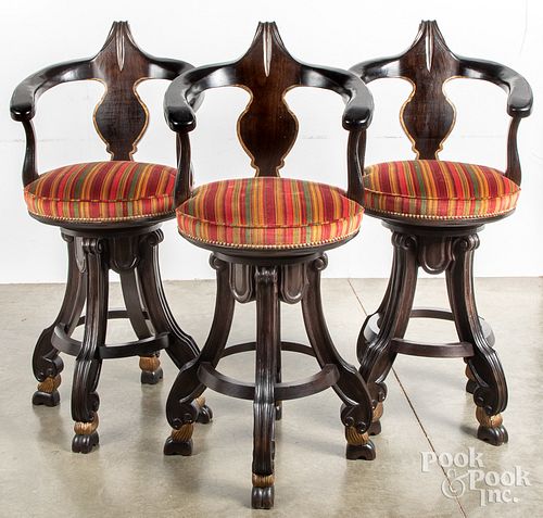 Set of three contemporary swivel bar stools.
