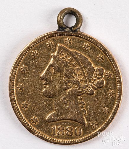 1880 five dollar Liberty head gold coin.
