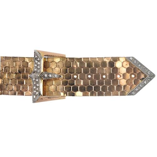 A mid 20th century 18ct gold diamond buckle bracelet. Designed as a wide hexagonal-link flexible bra