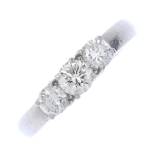 (181787) A platinum diamond three-stone ring. The slightly graduated brilliant-cuts diamonds to the