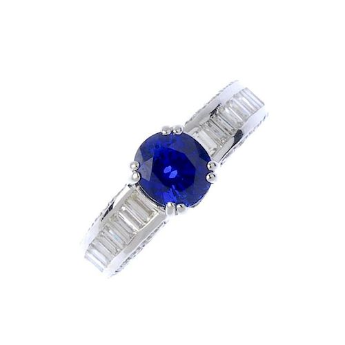 (193674) A sapphire and diamond ring. The oval-shape sapphire, to the baguette-cut diamond line shou