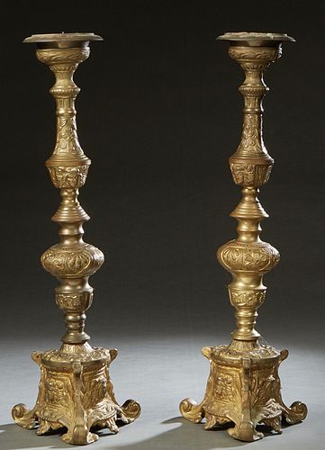 Pair of Gilt Bronze Candlesticks, late 19th c., with knopped floral and Egyptian masque supports, to a tripodal leaf and Egyptian masque decorated bas