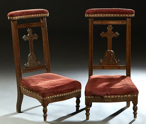 Pair of French Carved Beech Prie Dieus, 19th c., the curved upholstered armrest over a cruciform back splat, to a trapezoidal bowed seat, on turned le
