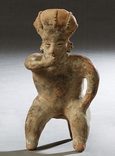 Pre-Columbian Pottery Figure, of a seated man with his hand in his mouth, H.- 10 1/2 in., W.- 5 1/2 in., D.- 4 3/4 in. in. Provenance: Palmira, the Es