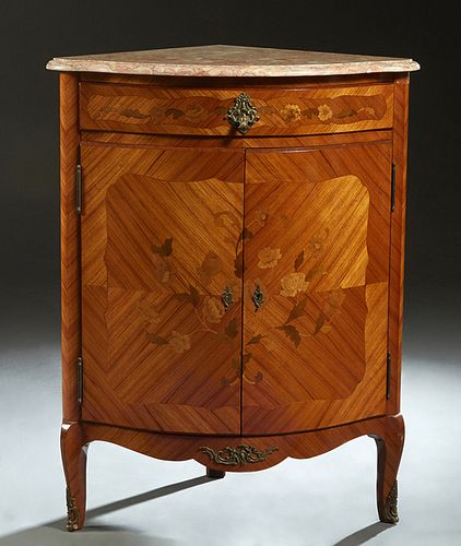 French Louis XV Style Marquetry Inlaid Marble Top Corner Cabinet, early 20th c., the highly figured rounded edge pink marble over a frieze drawer and 