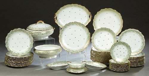 Fifty-Two Piece Set of Limoges Porcelain Dinnerware, 20th c., by Andre, with gilt rims and gilt tracery borders, consisting of 12 soup bowls, 10 salad