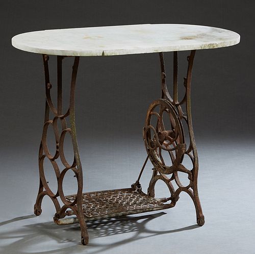 White Marble Top Patio Table, 20th c., the rounded side white marble on a cast iron sewing machine base, H.- 29 3/8 in., W.- 35 1/2 in., D.- 18 1/2 in