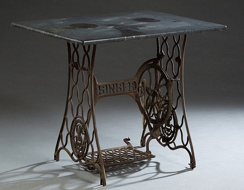 Black Marble Top Patio Table, early 20th c., the rectangular figured marble over a "Singer" sewing machine base, H.- 29 1/2 in., W.- 34 1/2 in., D.- 2