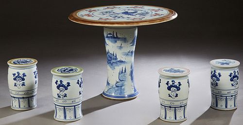 Chinese Porcelain Five Piece Patio Set, 20th c., consisting of a circular table with bird and tree decoration and four porcelain cylindrical stools, T