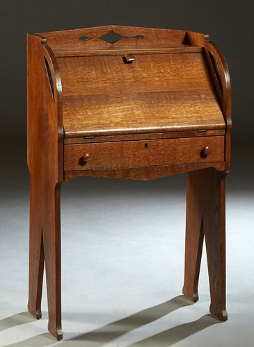 Diminutive Mission Oak Slant Front Secretary, c. 1910, possibly Liberty & Co, London, the interior fitted with a letter slot, on flat tapered trestle 