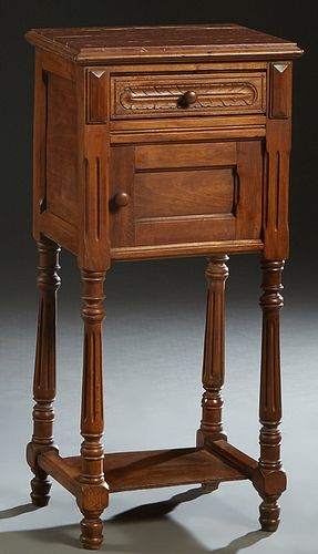 French Henri II Style Carved Walnut Marble Top Nightstand, late 19th c., the inset highly figured rouge marble over a frieze drawer and a pot cupboard