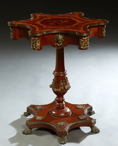 Ormolu Mounted Inlaid Mahogany Occasional Table, 20th c., the brass bound marquetry inlaid scalloped top over a curved skirt with masque mounts, on a 