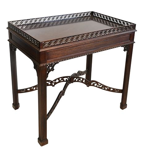Stickley Mahogany Center Table, having pierced gallery top, on fluted legs, arched pierced stretcher, height 30 inches, top 21 x 32 1/2 inches.