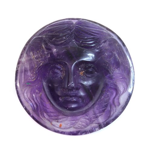 An unmounted circular carved amethyst cameo,