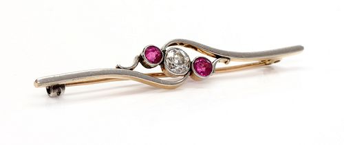 A three stone diamond and ruby crossover bar brooch,
