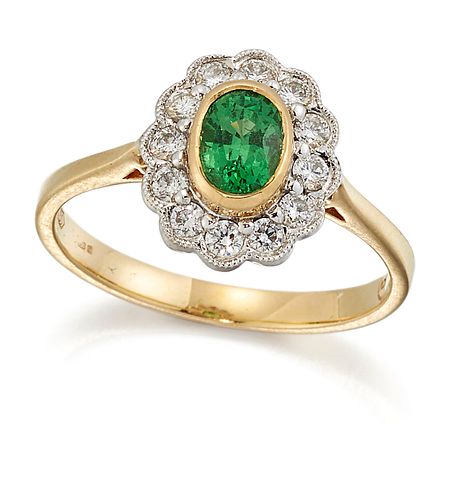AN 18 CARAT GOLD GREEN GARNET AND DIAMOND CLUSTER RING, an oval-cut green g