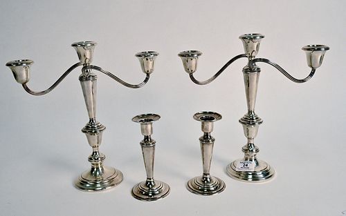 Two Pairs of Weighted Sterling, to include candle holders, a pair of sterling candelabras, along with a pair of candlesticks, ranging in size from 6 i