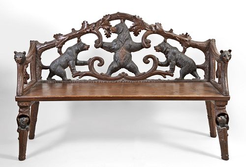 An early 20th century Black Forest bear carved linden arm chair and bench