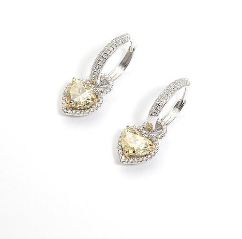A pair of colored diamond heart-shaped earrings