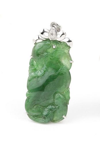 A carved jadite, diamond and white gold pendant
