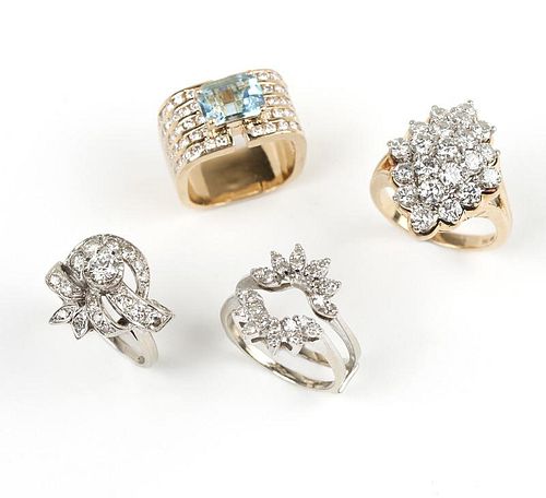 A group of four diamond and gold rings